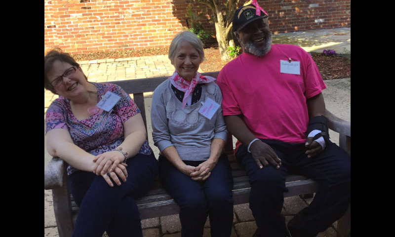 three adults smiling