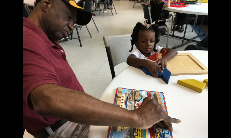 an adult and a child playing